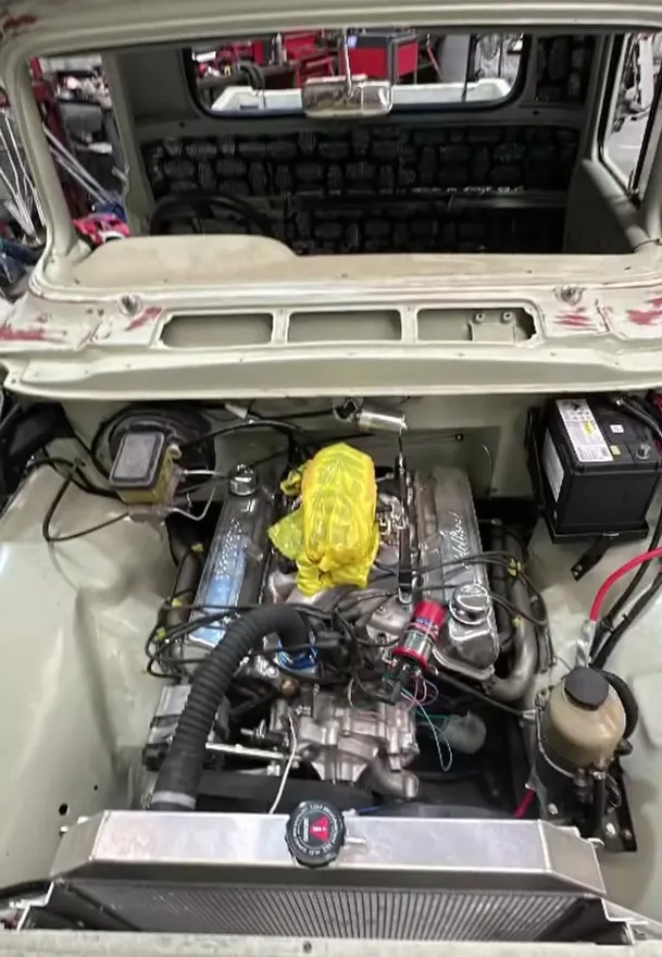 Engine bay of the same classic truck, rewired with the battery fitted