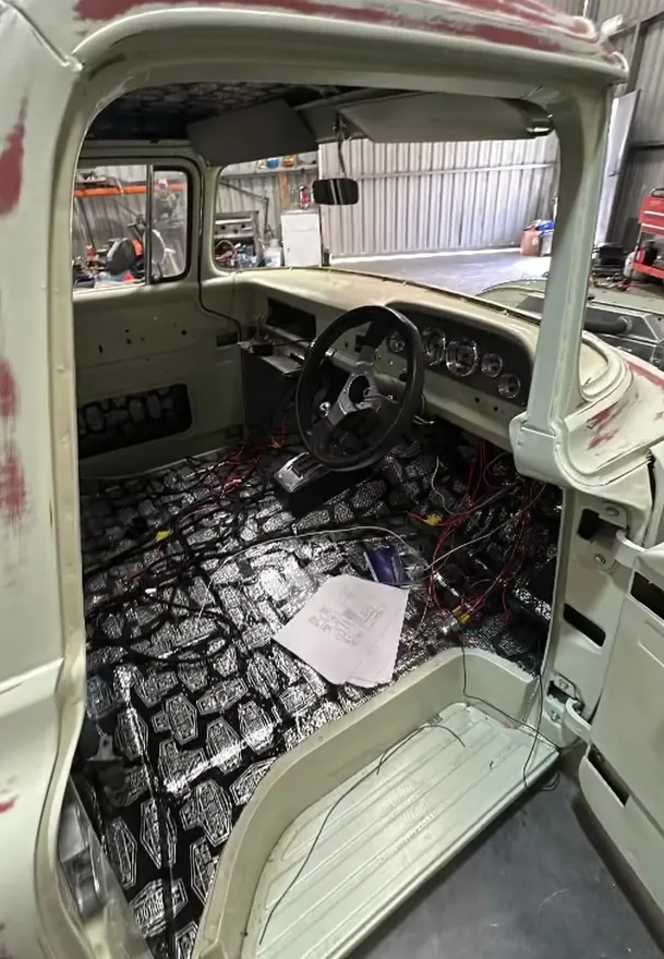 Classic truck cab stripped back with new wiring laid out across the floor