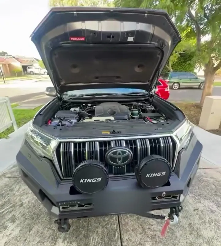 Prado 150 with bonnet up and two round driving lights on the bar